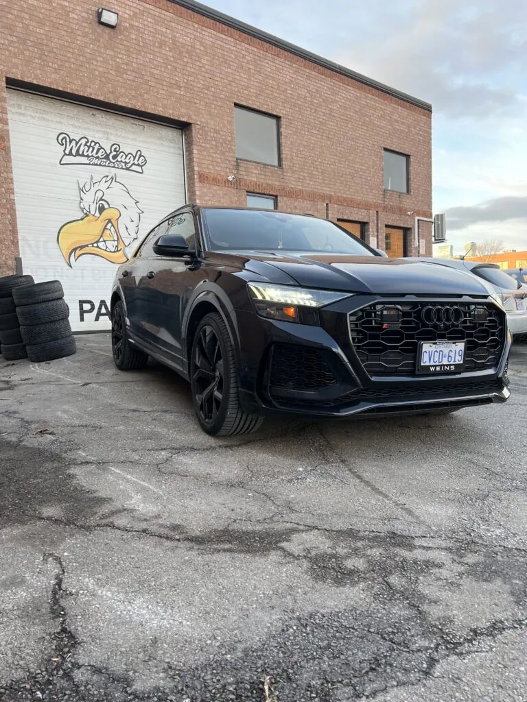 Black Audi SUV parked outside the White Eagle Motors shop