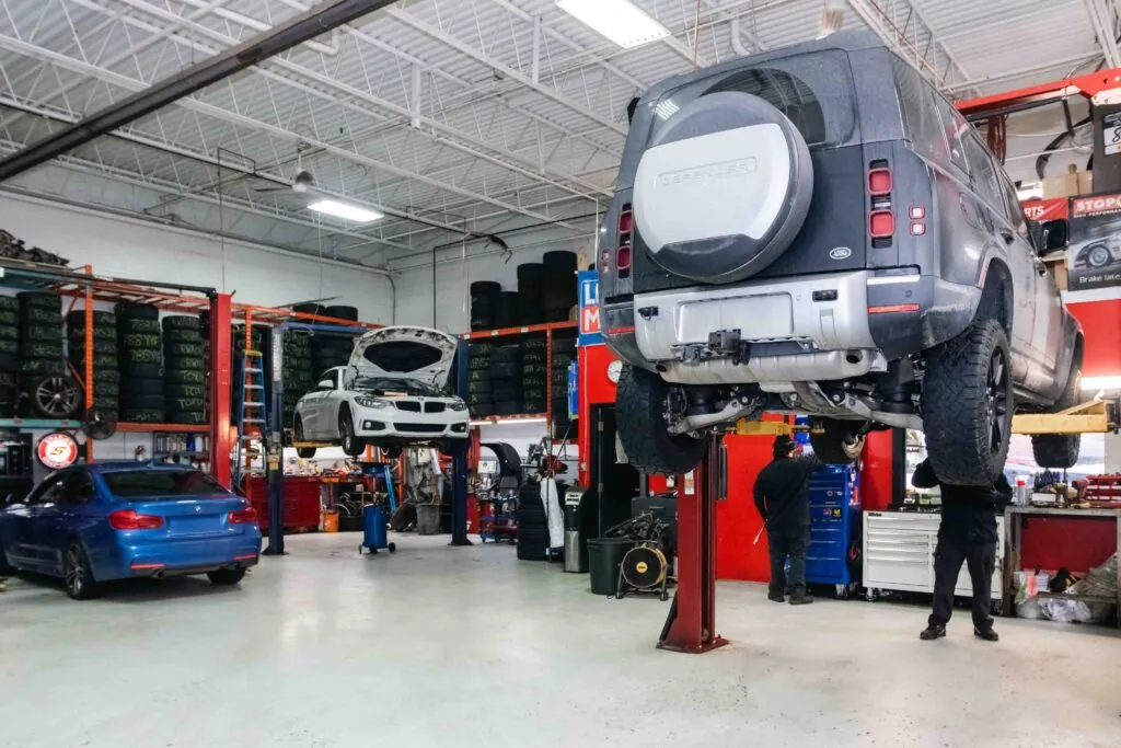 Land Rover Defender on the hoist in the White Eagle Motors service bay